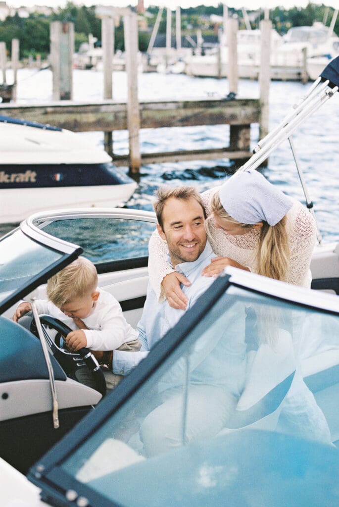 candid moment between a family of three on their boat during a family session