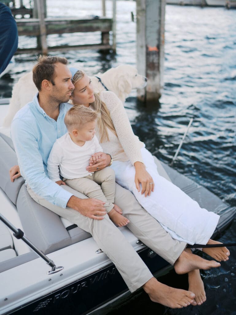 A candid moment of a family on their boat during a family session on the lake.